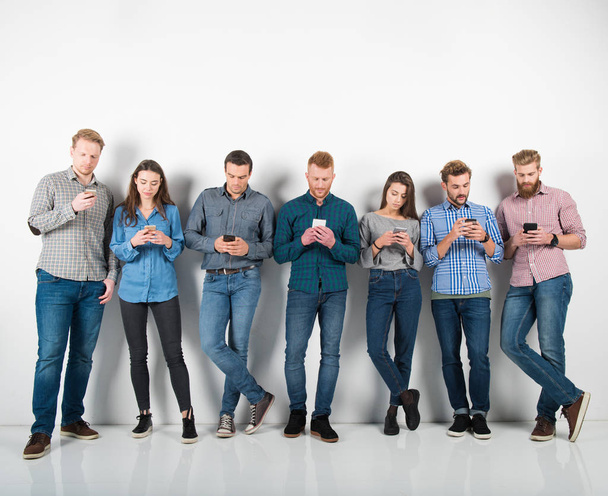 Group of boys and girls connected with their smartphones. Concept of internet and social network - Foto, afbeelding