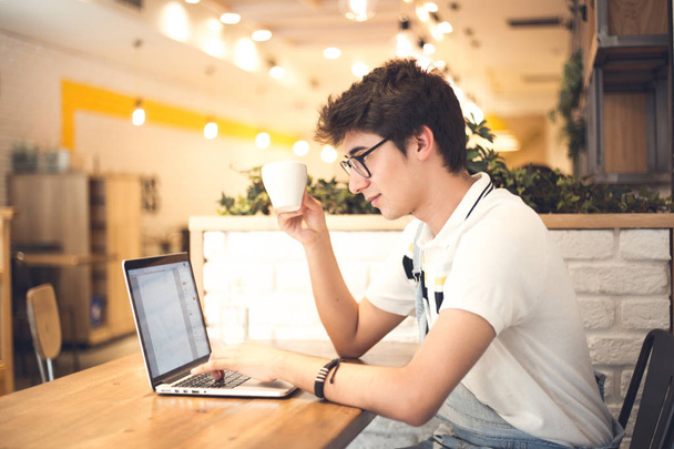 young handsome man in cafe using laptop  - Φωτογραφία, εικόνα