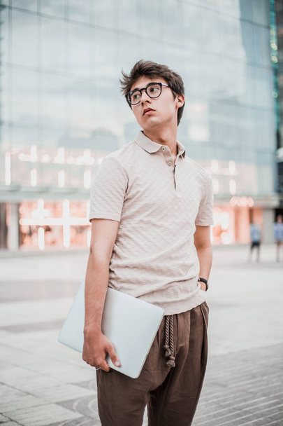 outdoor portrait of young handsome man in glasses  - 写真・画像
