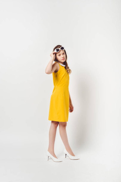 beautiful teenage child in yellow dress on white - Foto, Imagem