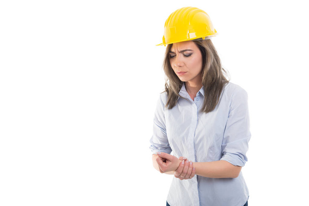 Portrait of female constructor holding her wris - Photo, Image