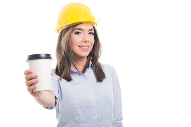 Pretty female constructor offering takeaway coffe - Foto, Imagem