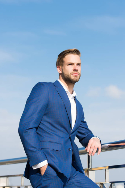 Businessman stand on blue sky, success, ambition, freedom, achievement - Fotó, kép