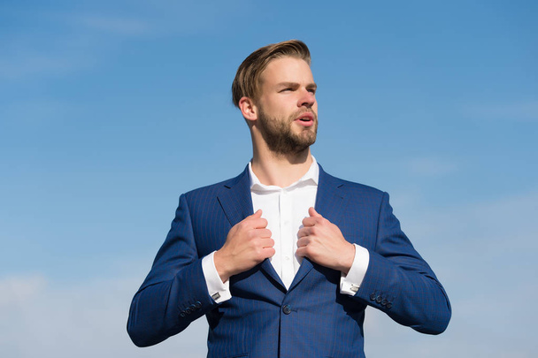 Businessman stand on blue sky, success - Фото, изображение