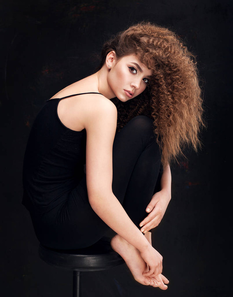 Very beautiful girl model with afro curls and in fashion pose - 写真・画像