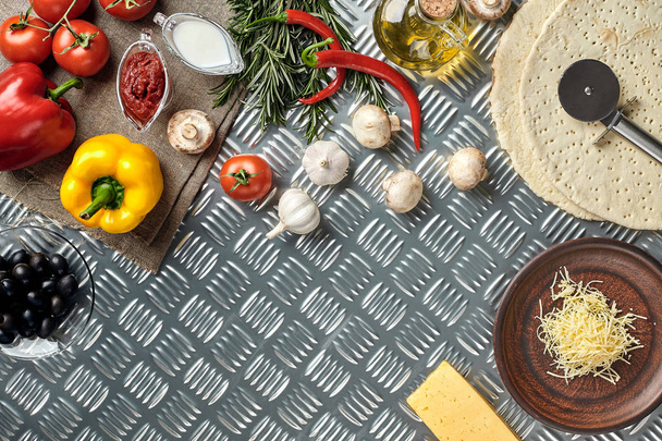 Cheese, different vegetables on metal table. Ingredients for traditional italian pizza. - Photo, Image