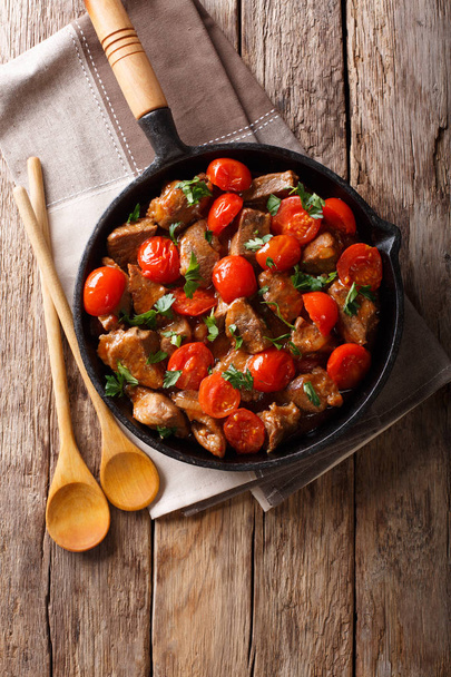 Veal in spicy sauce with cherry tomatoes and greens close-up in  - Photo, Image