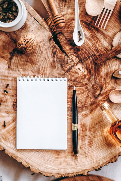 Elfűrészelt fa jegyzetfüzet, toll és a különböző elemek a háttérben - Fotó, kép
