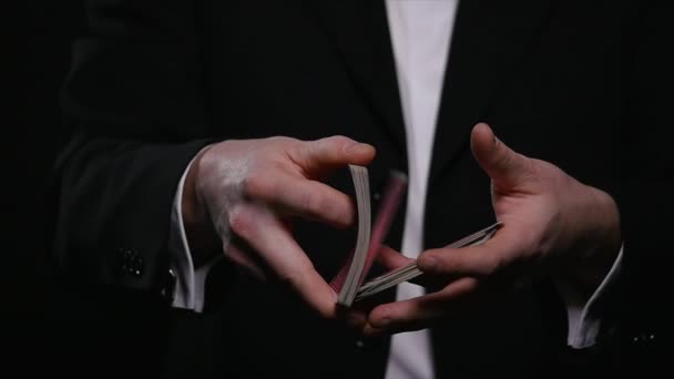 magic, card tricks, gambling, casino, poker concept - man showing trick with playing cards - Materiaali, video