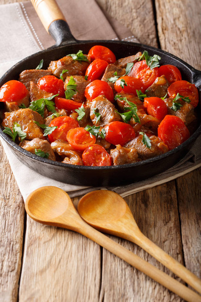 Veal in spicy sauce with cherry tomatoes and greens close-up in  - Photo, Image