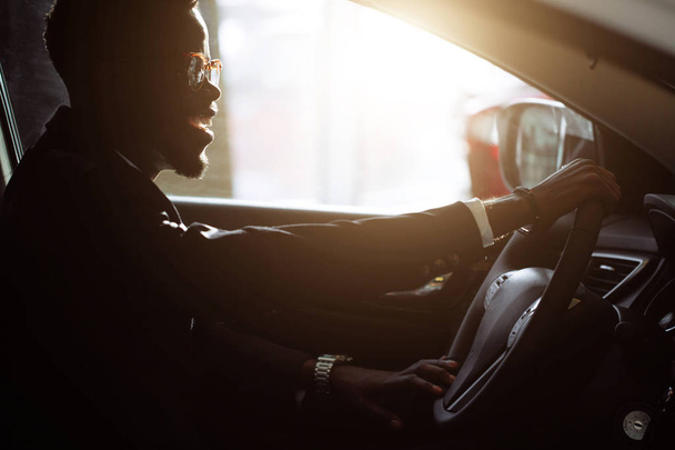 Stylish black man in car - 写真・画像