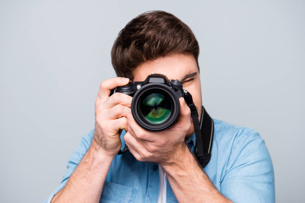 Portrait of guy in jeans shirt looking at photo camera, shooting - Φωτογραφία, εικόνα