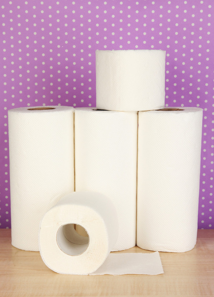 Rolls of toilet paper on purple with dots background - 写真・画像