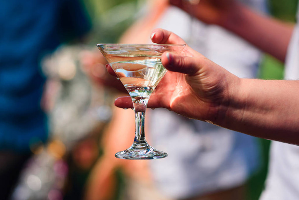 womens hand with a glass of Martini close-up - 写真・画像