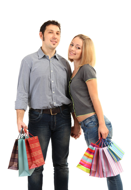 Young couple shopping and holding many shopping bags isolated on white - Φωτογραφία, εικόνα