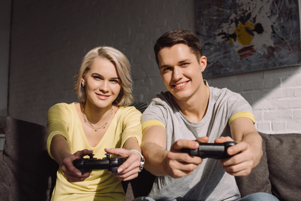 happy couple playing video game at home - Photo, Image