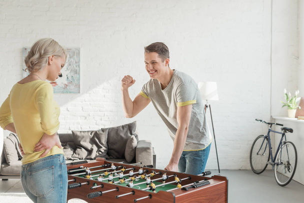boyfriend showing yes gesture when winning table football game - Valokuva, kuva