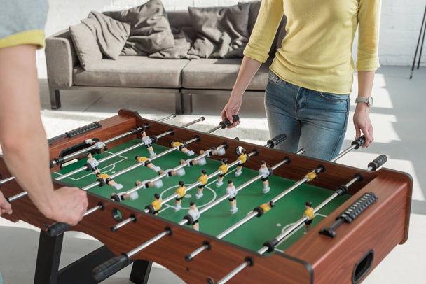 cropped image of couple playing table football at home - Fotografie, Obrázek