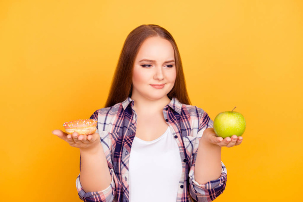 Healthy vs unhealthy eating. Portrait of thoughtful pensive mind - Фото, изображение