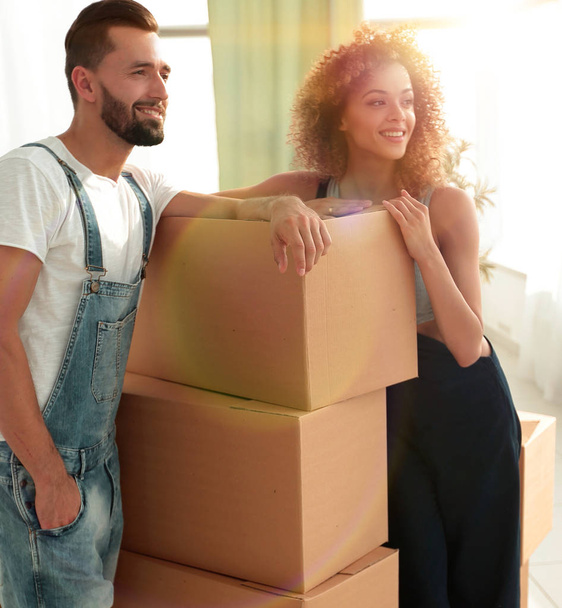 couple standing next to boxes when moving to a new house - Fotó, kép