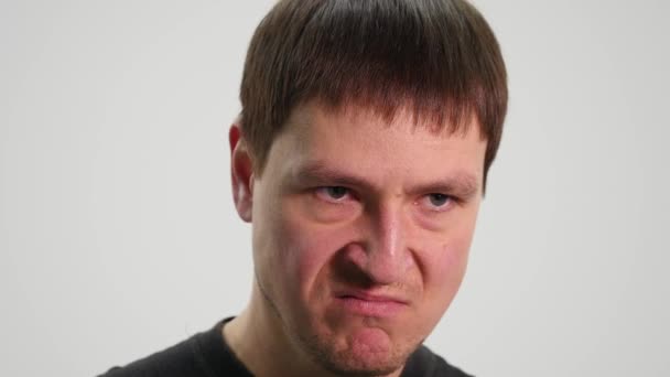 Angry man on white background. close up - Felvétel, videó