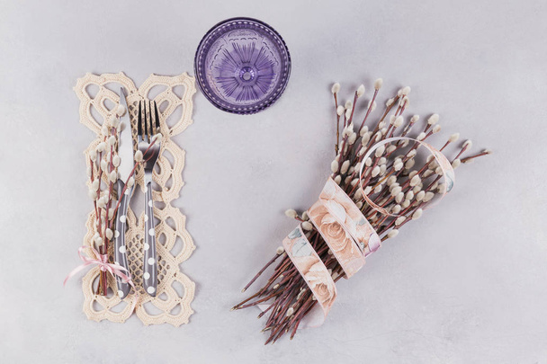 Purple glass, tableware, lace napkin and pussy willow twigs - Zdjęcie, obraz