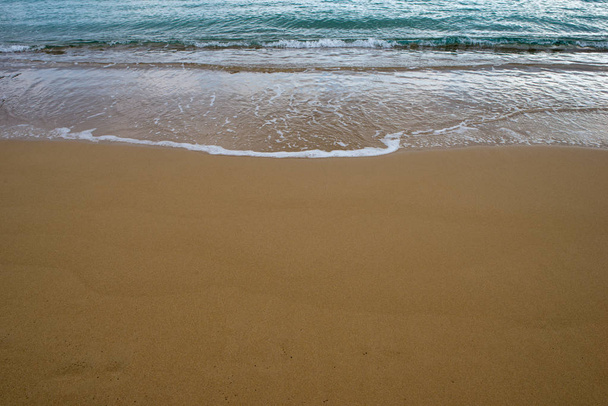 Waves on the seashore with golden sand - Фото, зображення