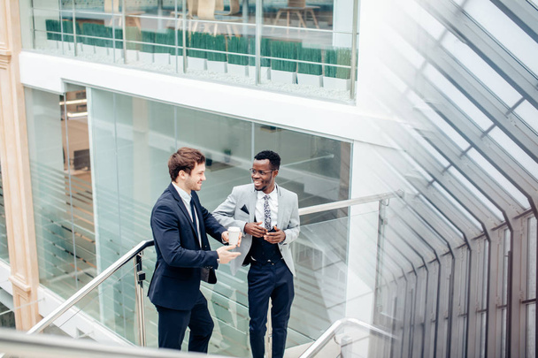 two multiracial Businessmen Discussion in modern hall - Фото, зображення