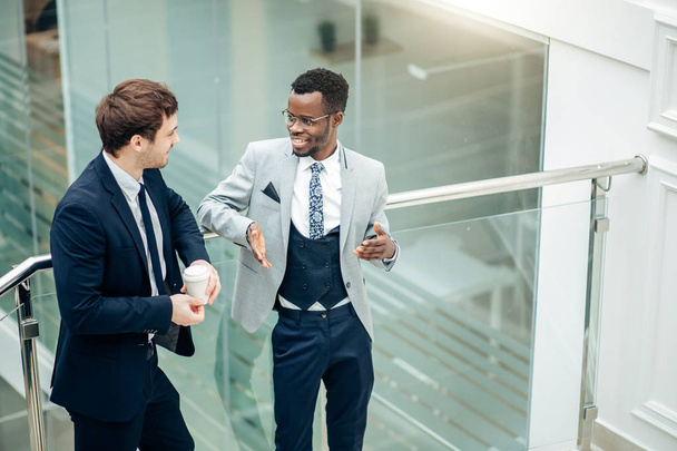 two multiracial Businessmen Discussion in modern hall - Фото, зображення