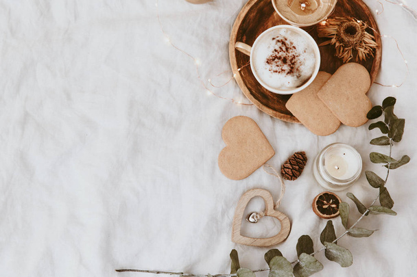 Coffee Cup, Cookies and Decorations in Bed. Sweet Home, Still Life Concept. Flat lay, Top view, Copy Space  - Photo, Image