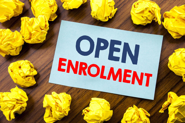Conceptual hand writing text inspiration showing Open Enrolment. Business concept for Medicine Doctor Enroll written on sticky note paper on the wooden background with folded yellow paper - Photo, Image