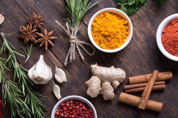 Colorful herbs and spices selection. Aromatic ingredients on wood table - Φωτογραφία, εικόνα
