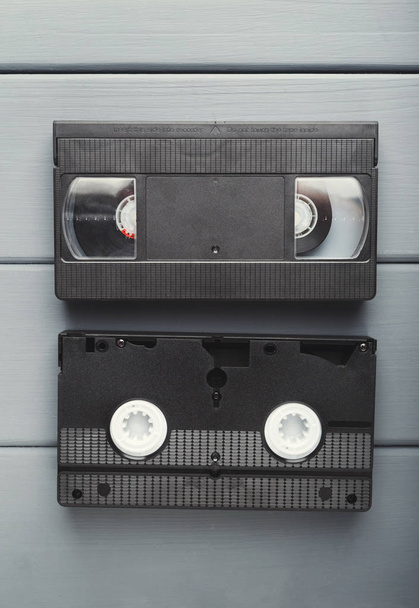 Video cassettes on gray wooden surface . Back to the past - Photo, Image