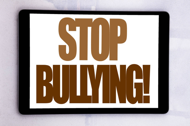 Hand writing text caption inspiration showing Stop Bullying. Business concept for Prevention Problem Bully written on tablet screen on the white background. - Photo, Image