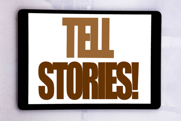 Hand writing text caption inspiration showing Tell Stories. Business concept for Storytelling Telling Story written on tablet screen on the white background. - Photo, Image