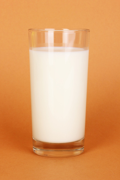 Glass of fresh new milk on brown background - Photo, image