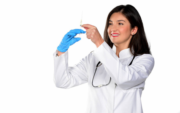 Young female doctor holding a syringe. isolated on white background - Photo, image