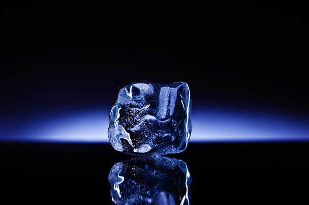 A professionally formed piece of ice on reflecting surface. - Valokuva, kuva
