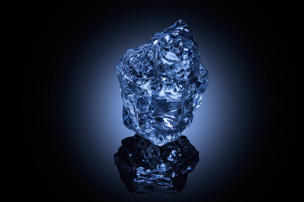 A professionally formed piece of ice on reflecting surface. - Zdjęcie, obraz