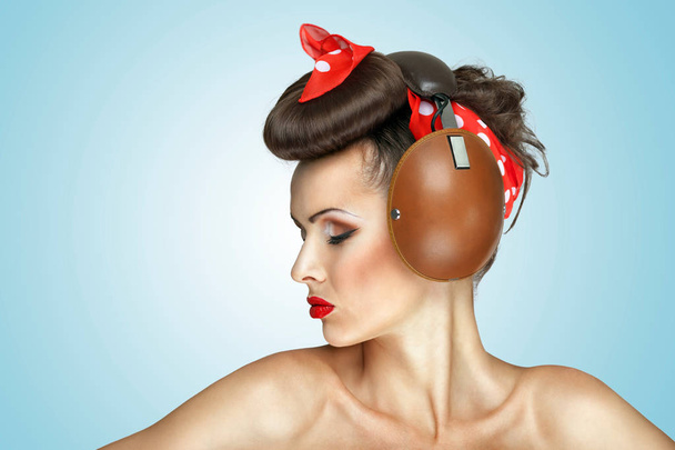 The retro photo of cute girl in vintage headphones listening to the music. - Φωτογραφία, εικόνα