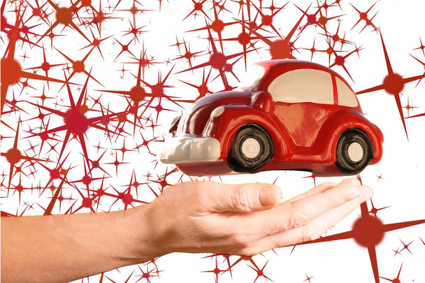 Modèle de voiture jouet rouge au-dessus de la main de la femme sur un fond blanc avec forme d'étoiles rouges
. - Photo, image