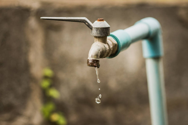 Faucet with a water drop / Water consumption concept - Photo, Image