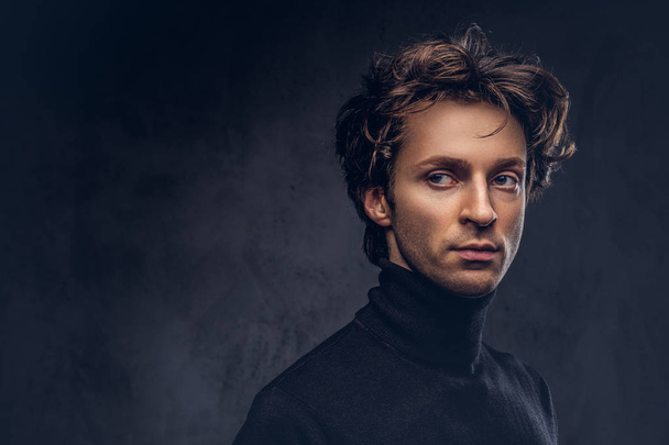 Portrait of a charismatic sensual male in black sweater. Creative personality. - Photo, Image