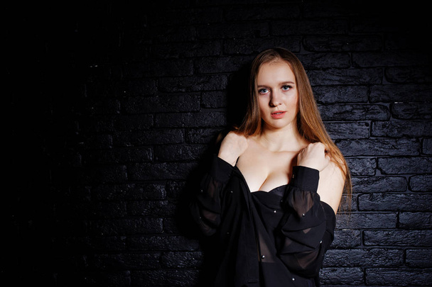 Studio shot of brunette girl in black blouse with bra and shorts - Fotografie, Obrázek