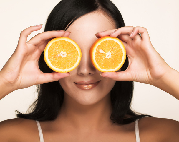 Cheerful woman with fresh orange - Fotografie, Obrázek