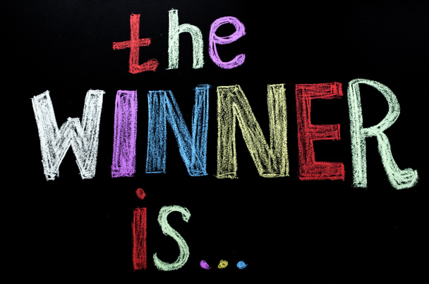 colored hand written text 'the winner is ' on chalkboard - Photo, Image