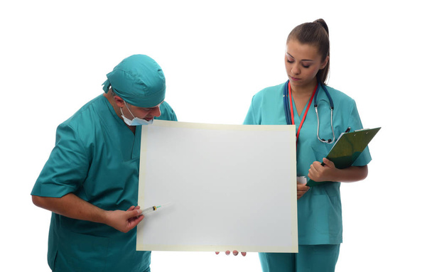 doctor and nurse holding white empty board. isolated on white background - Photo, Image