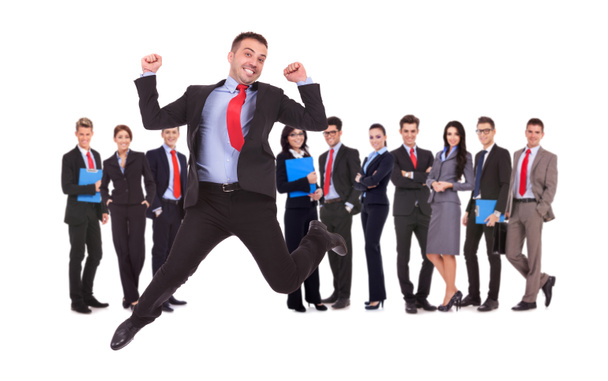Business man jumping in front of his business team - Фото, изображение