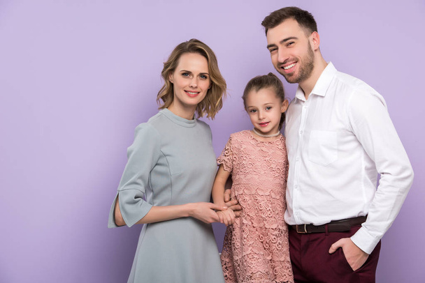 Adorable family with daughter isolated on violet - Foto, afbeelding
