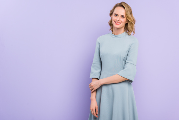 Smiling blonde woman isolated on violet - Photo, Image
